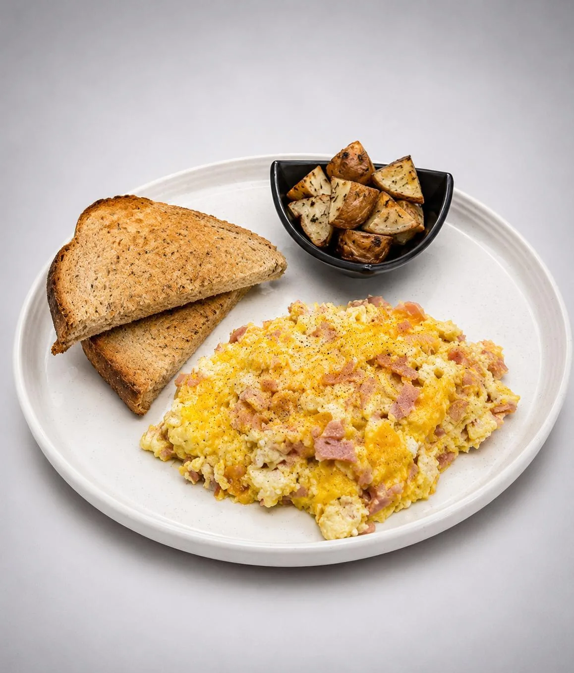 The Morning Melt with scrambled eggs, ham, potatoes and toast