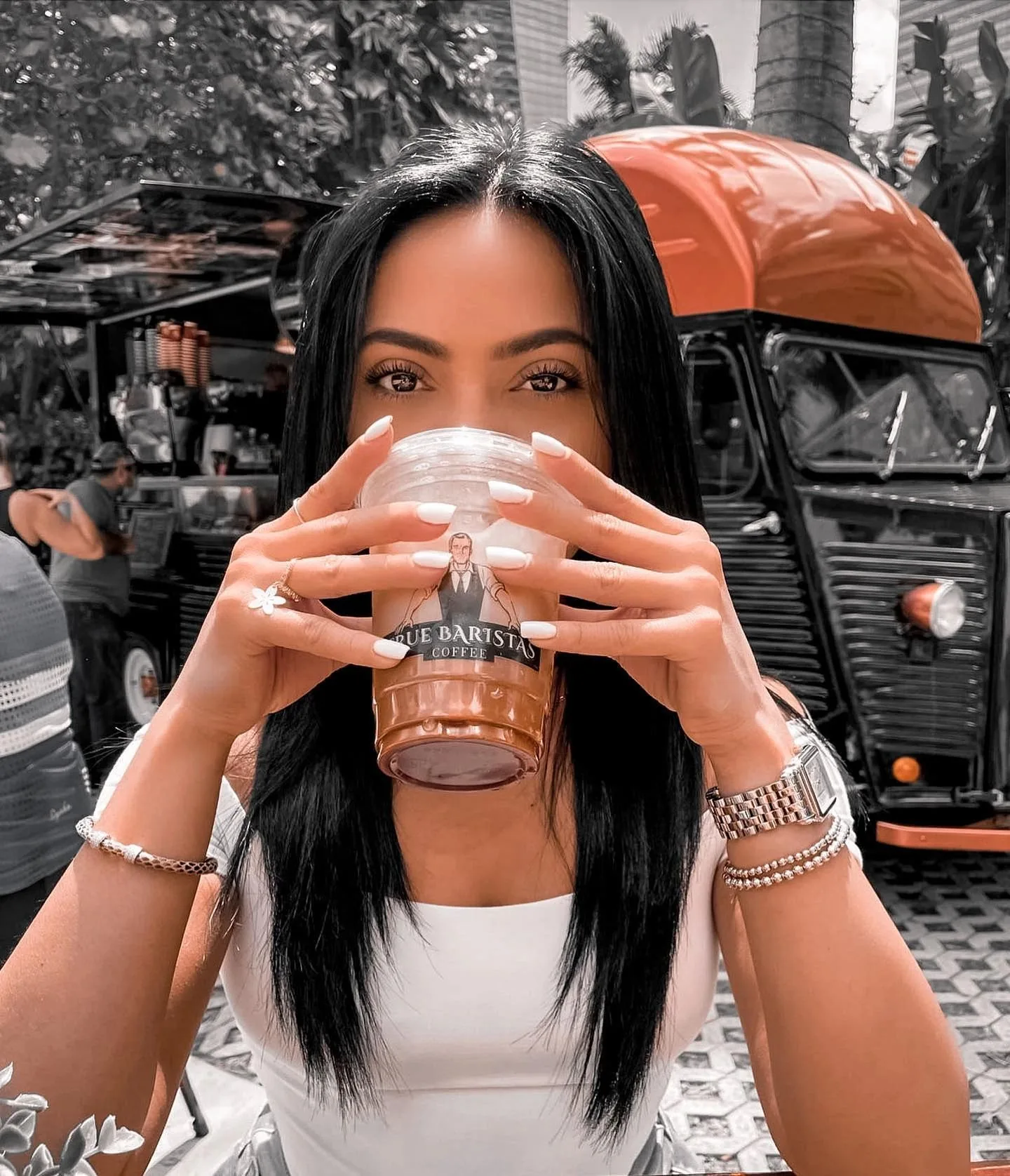 A guest enjoying a drink beside the True Baristas vintage coffee truck